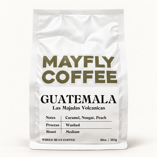 A white stand-up coffee bag labeled MAYFLY COFFEE Guatemala, with black and olive text on a white background.